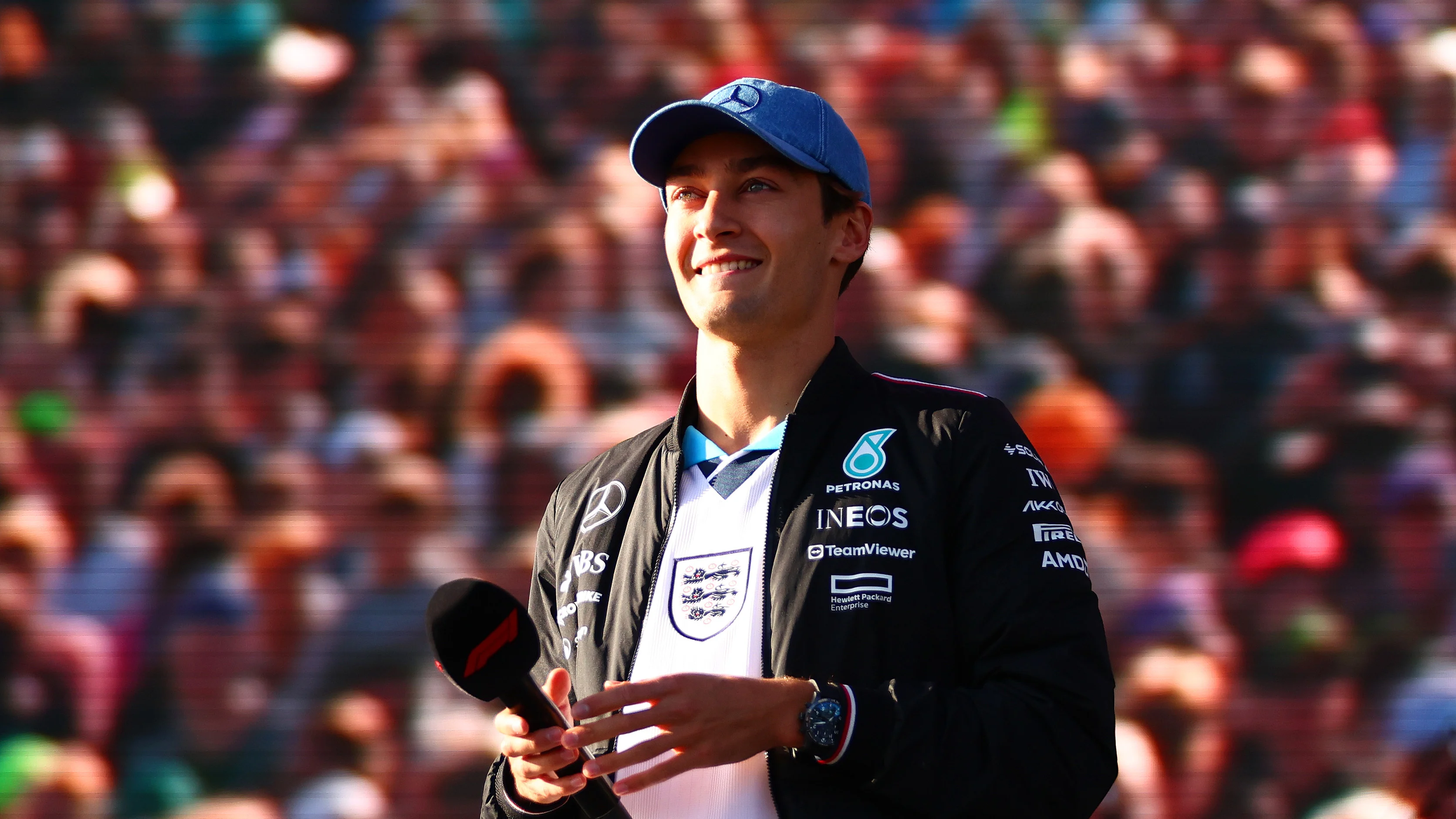 NORTHAMPTON, ENGLAND - JULY 06: George Russell of Great Britain and Mercedes talks to the crowd on