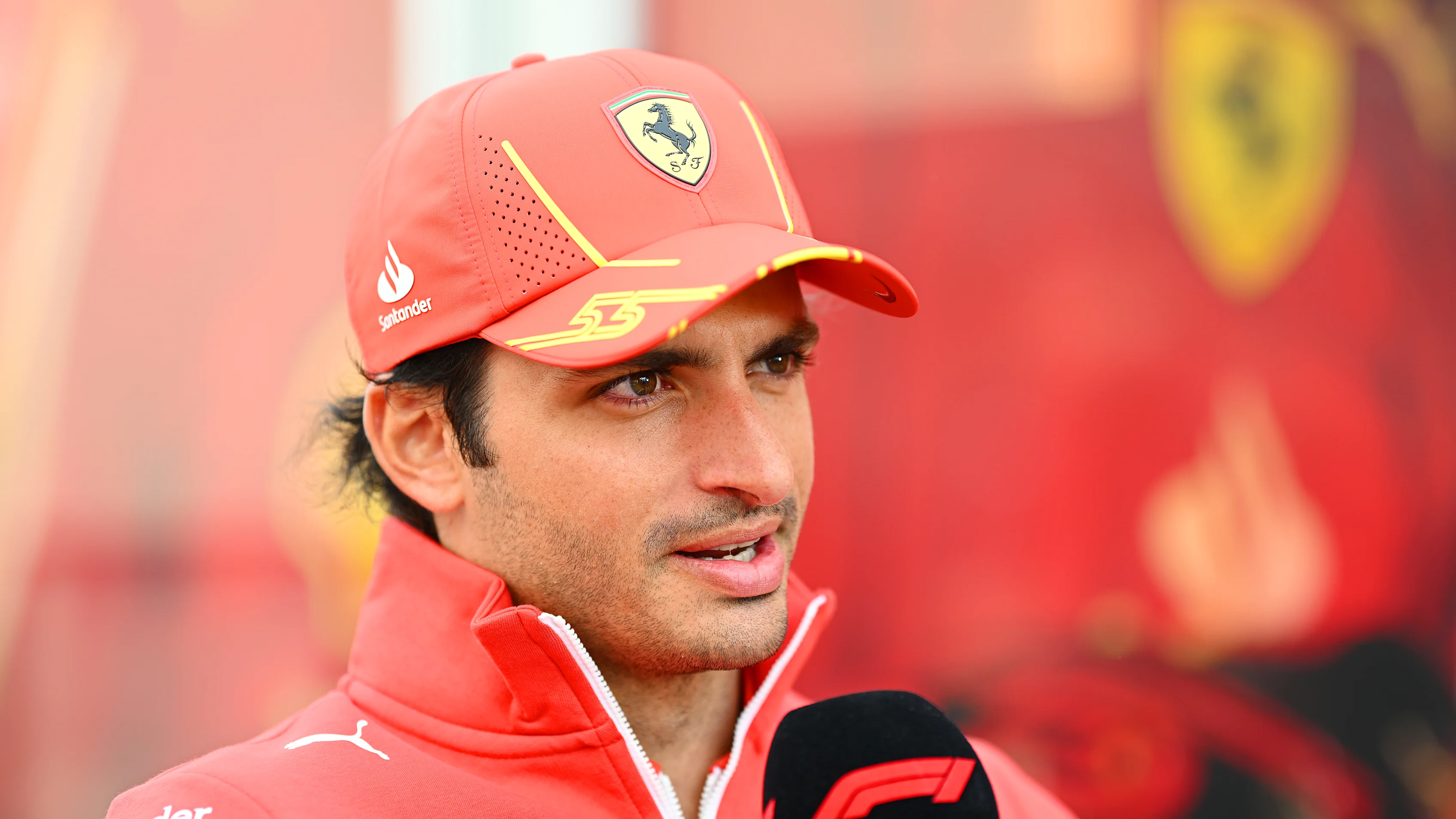 SUZUKA, JAPAN - APRIL 04: Carlos Sainz of Spain and Ferrari talks to the media in the Paddock