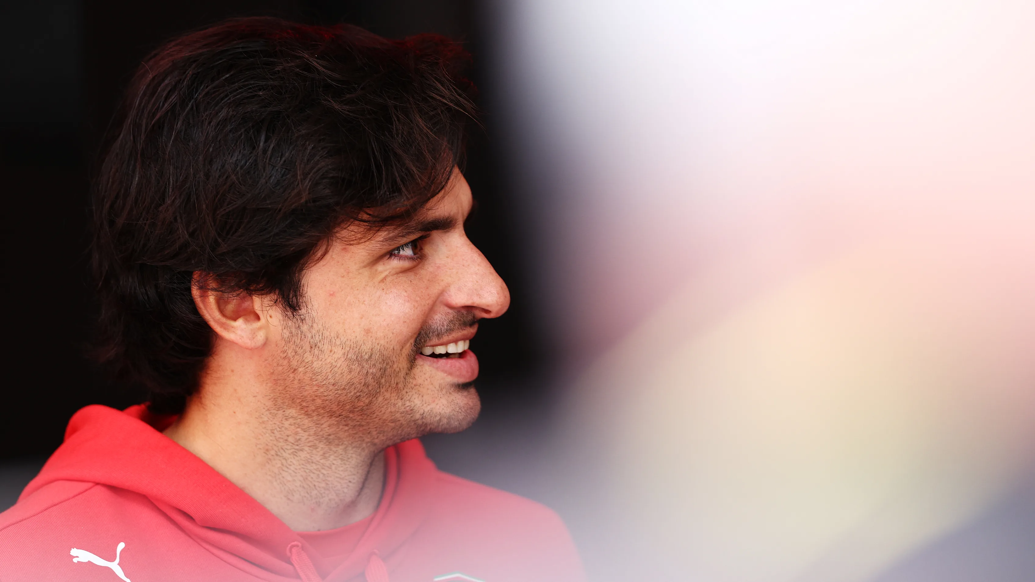 AUSTIN, TEXAS - OCTOBER 17: Carlos Sainz of Spain and Ferrari looks on in the Paddock during