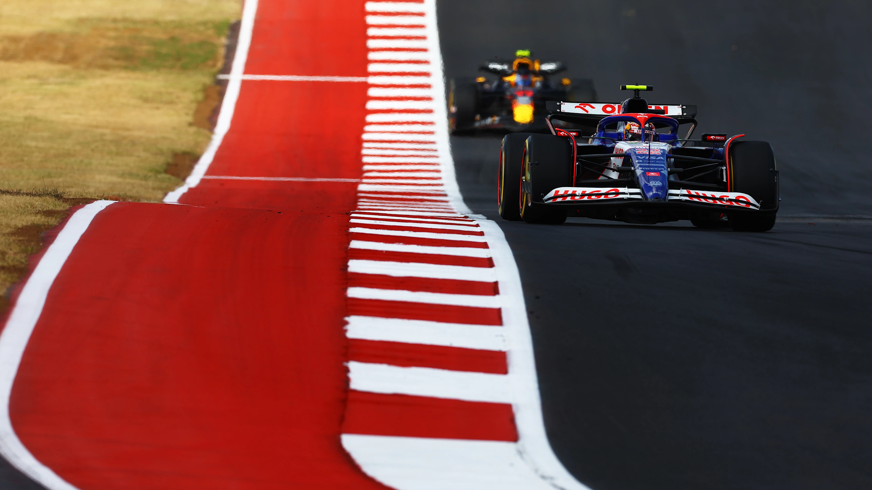 AUSTIN, TEXAS - OCTOBER 19: Yuki Tsunoda of Japan driving the (22) Visa Cash App RB VCARB 01 leads