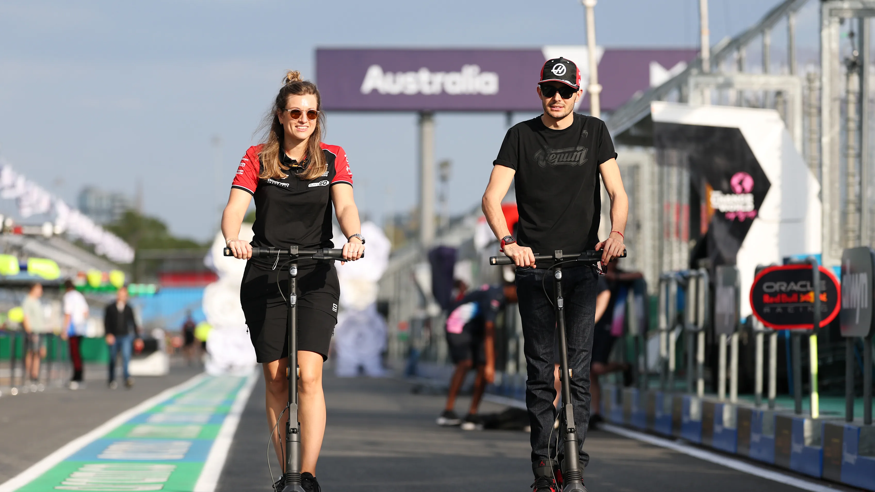 MELBOURNE, AUSTRALIA - MARCH 12: Esteban Ocon of France and Haas F1 rides a scooter in the pitlane