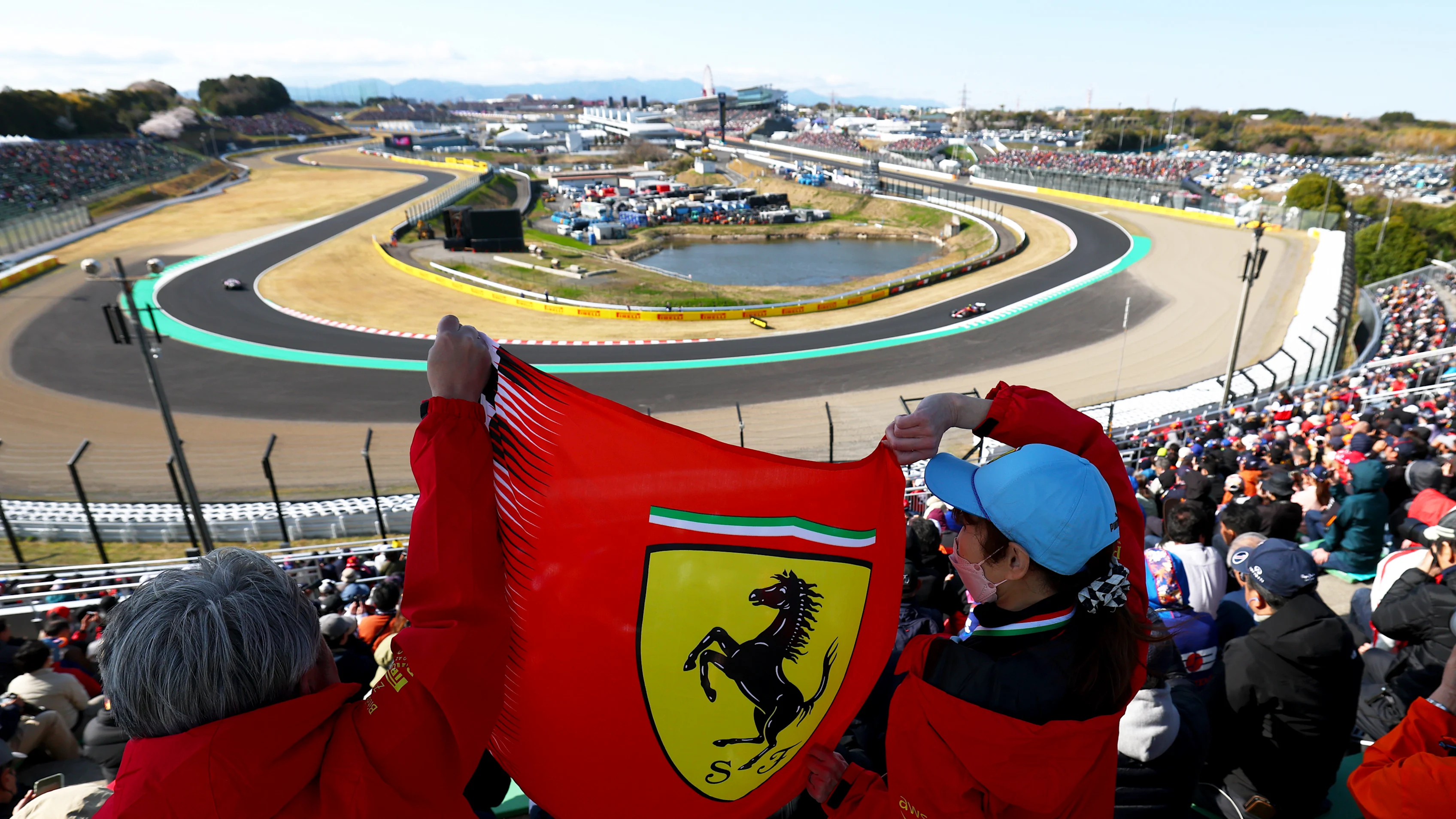 SUZUKA, JAPAN - APRIL 04: Ferrari fans cheer from a grandstand as Lewis Hamilton of Great Britain