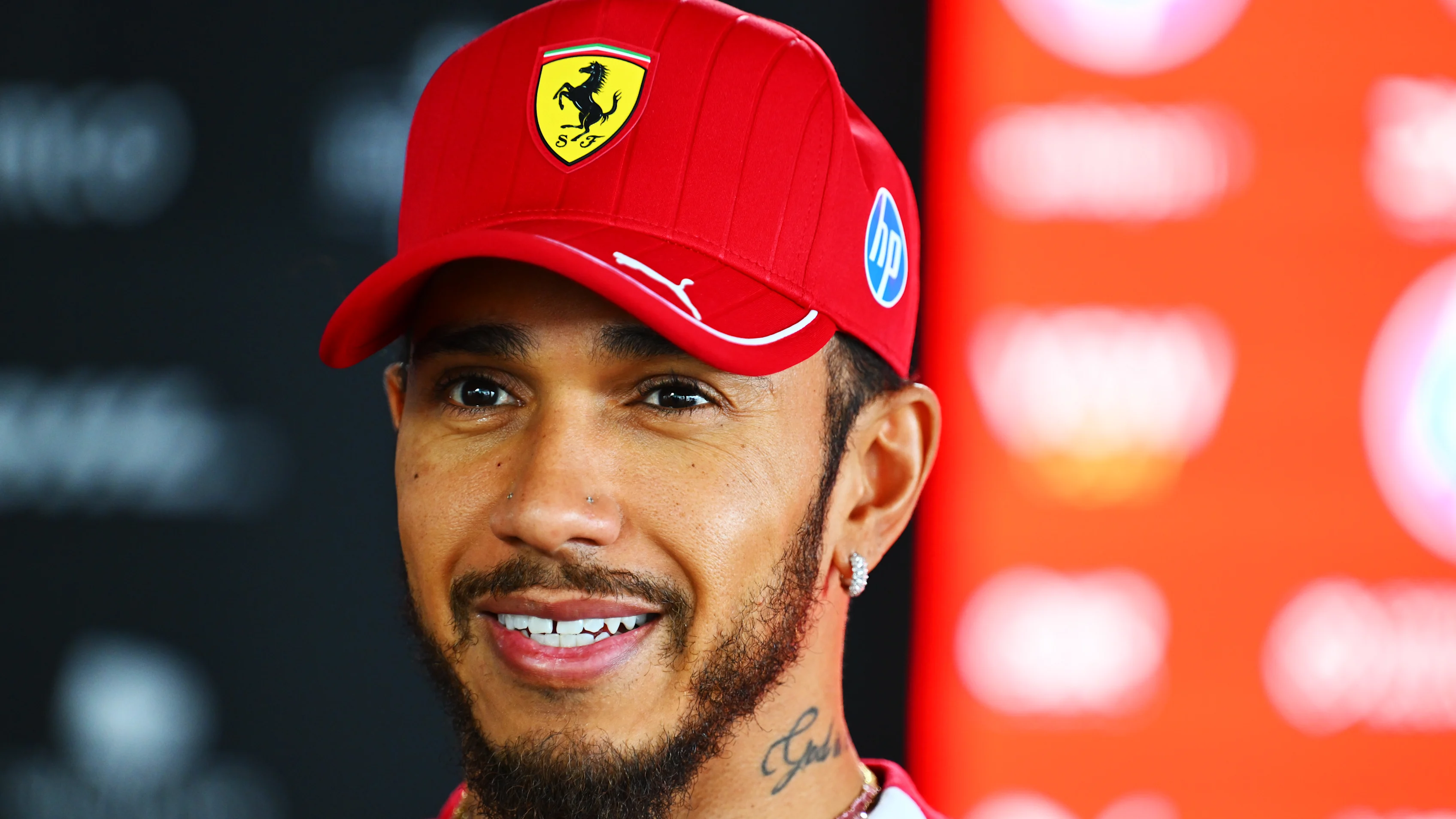 SUZUKA, JAPAN - APRIL 03: Lewis Hamilton of Great Britain and Scuderia Ferrari talks to the media