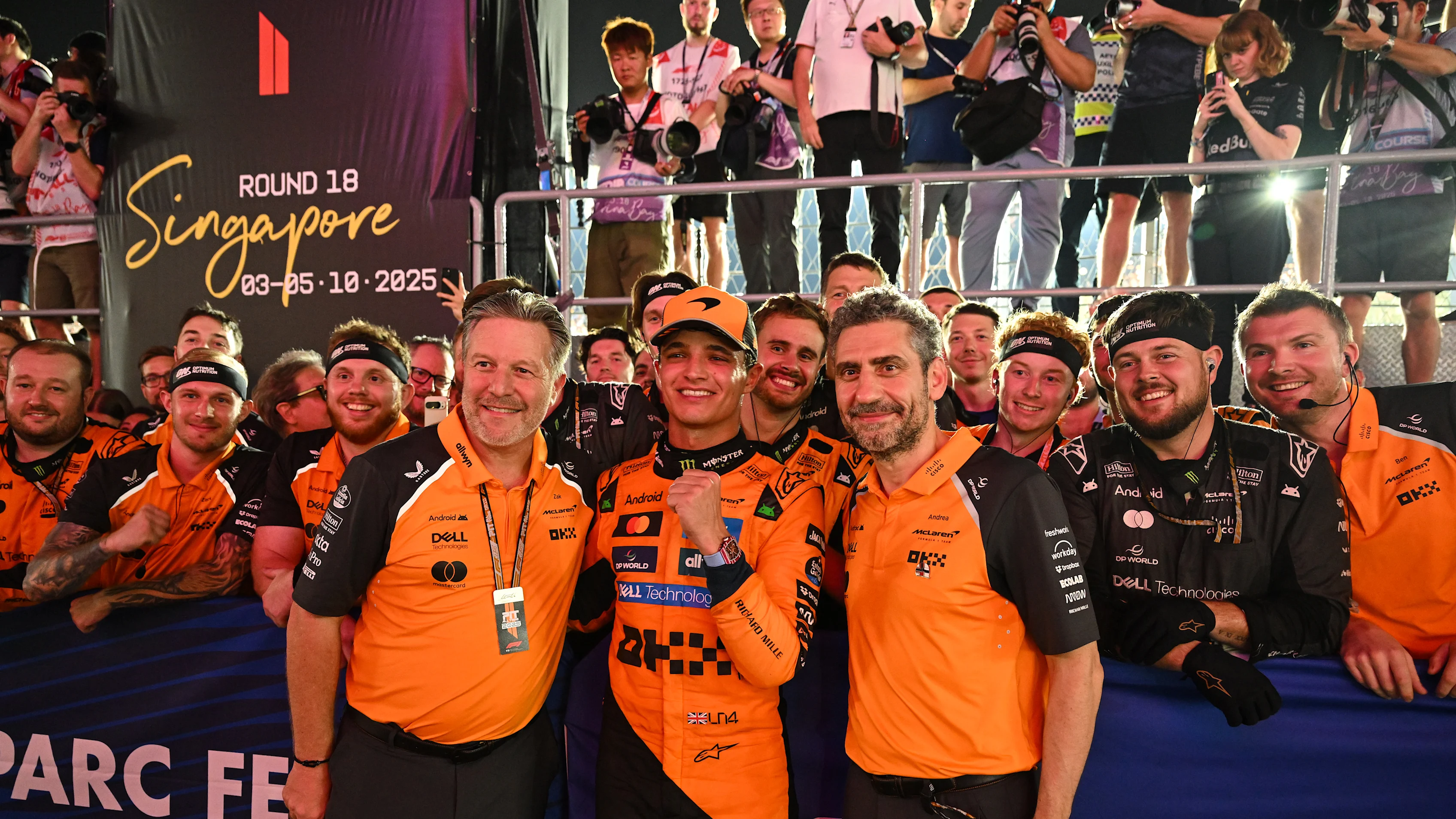 SINGAPORE, SINGAPORE - OCTOBER 05: Zak Brown, Chief Executive Officer of McLaren, Third placed Lando Norris of Great Britain and McLaren and Andrea Stella, Team Principal of McLaren celebrate winning the 2025 World Constructors Championship in parc ferme during the F1 Grand Prix of Singapore at Marina Bay Street Circuit on October 05, 2025 in Singapore, Singapore. (Photo by Mark Sutton - Formula 1/Formula 1 via Getty Images)