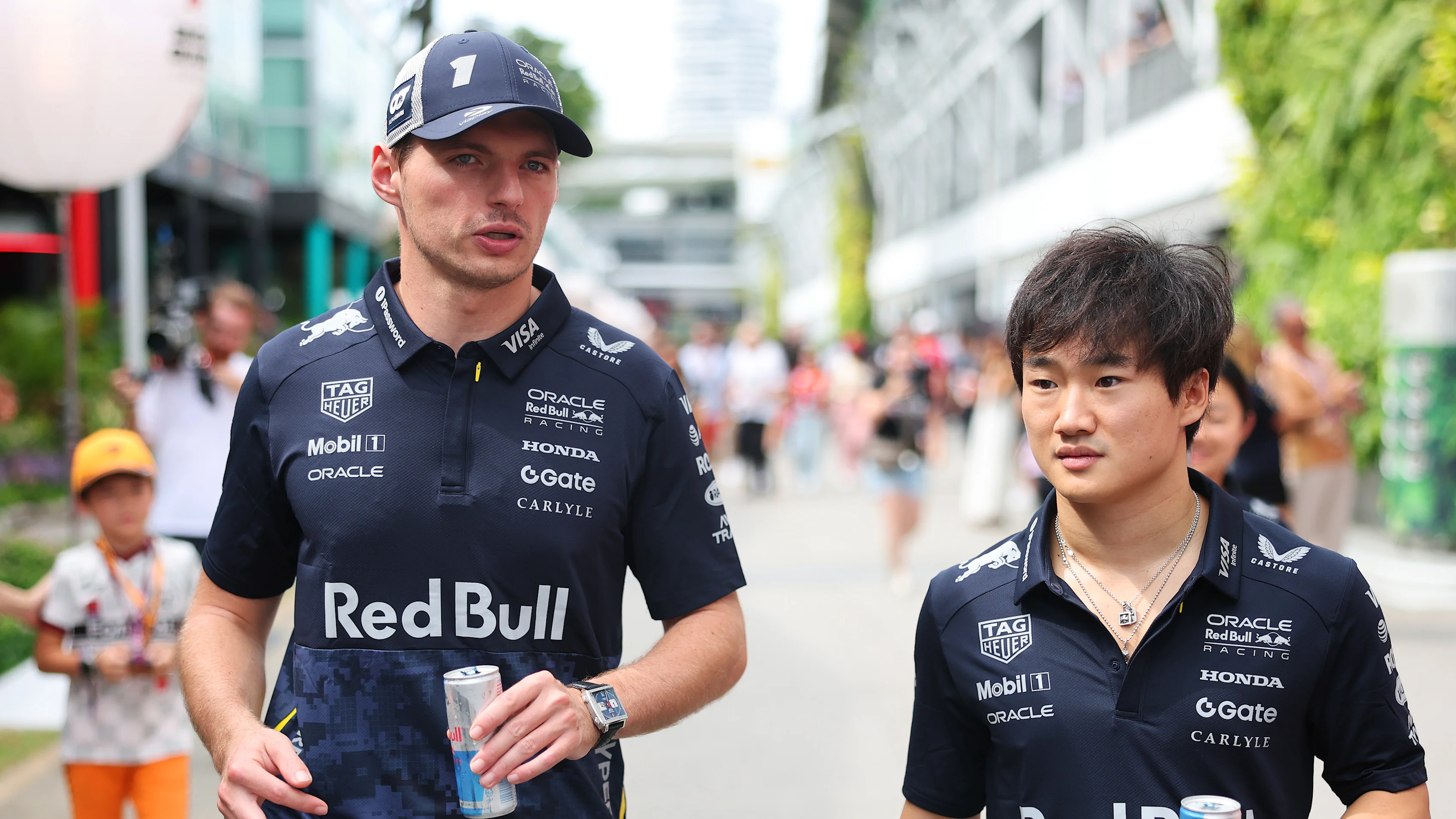 Max Verstappen and Yuki Tsunoda wearing the Red Bull x HYPEBEAST capsule collection, specifically designed for night races. Swipe for more images