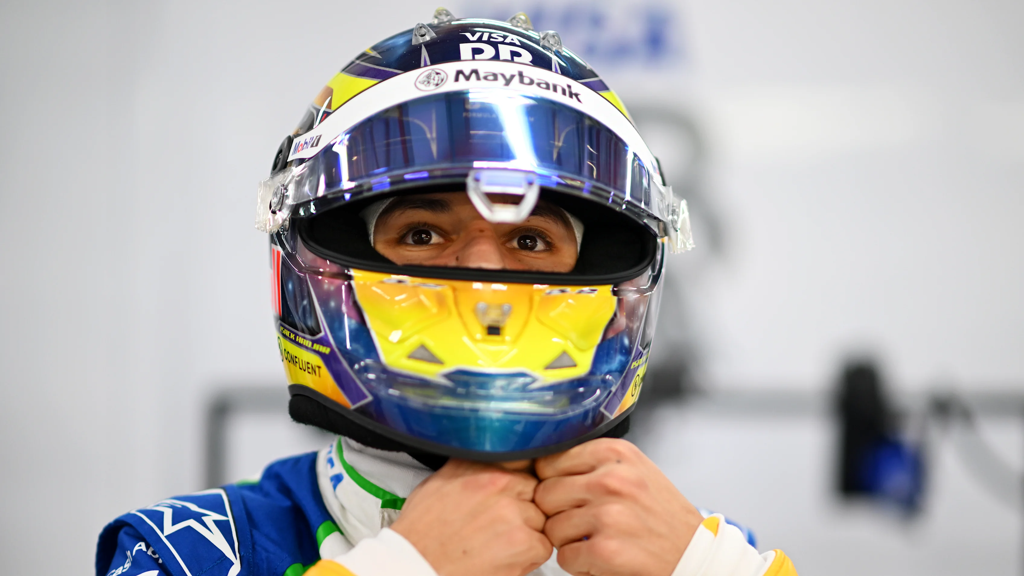 SINGAPORE, SINGAPORE - OCTOBER 04: Isack Hadjar of France and Visa Cash App Racing Bulls prepares to drive in the garage during qualifying ahead of the F1 Grand Prix of Singapore at Marina Bay Street Circuit on October 04, 2025 in Singapore, Singapore. (Photo by Rudy Carezzevoli/Getty Images)