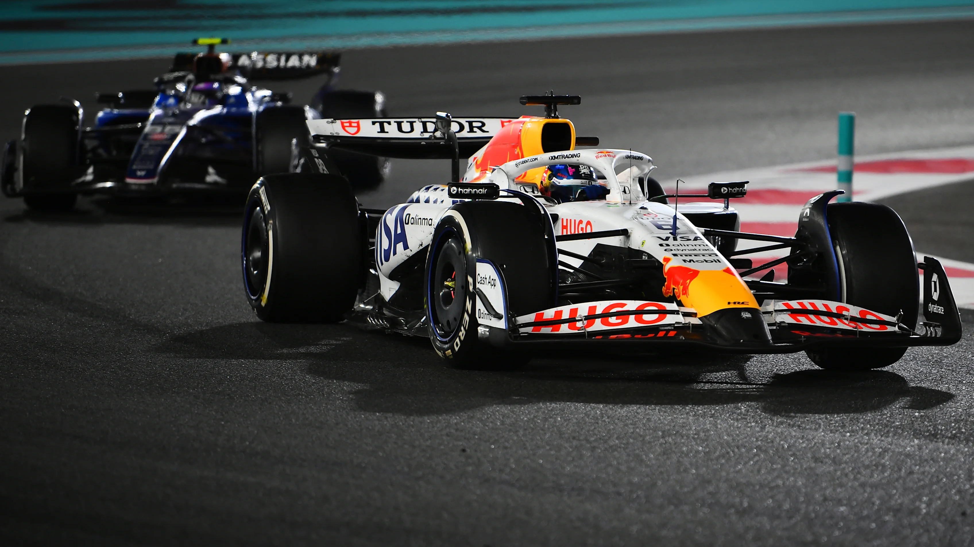 ABU DHABI, UNITED ARAB EMIRATES - DECEMBER 07: Isack Hadjar of France driving the (6) Visa Cash App Racing Bulls VCARB 02 leads Carlos Sainz of Spain driving the (55) Williams FW47 Mercedes on track during the F1 Grand Prix of Abu Dhabi at Yas Marina Circuit on December 07, 2025 in Abu Dhabi, United Arab Emirates. (Photo by James Sutton - Formula 1/Formula 1 via Getty Images)