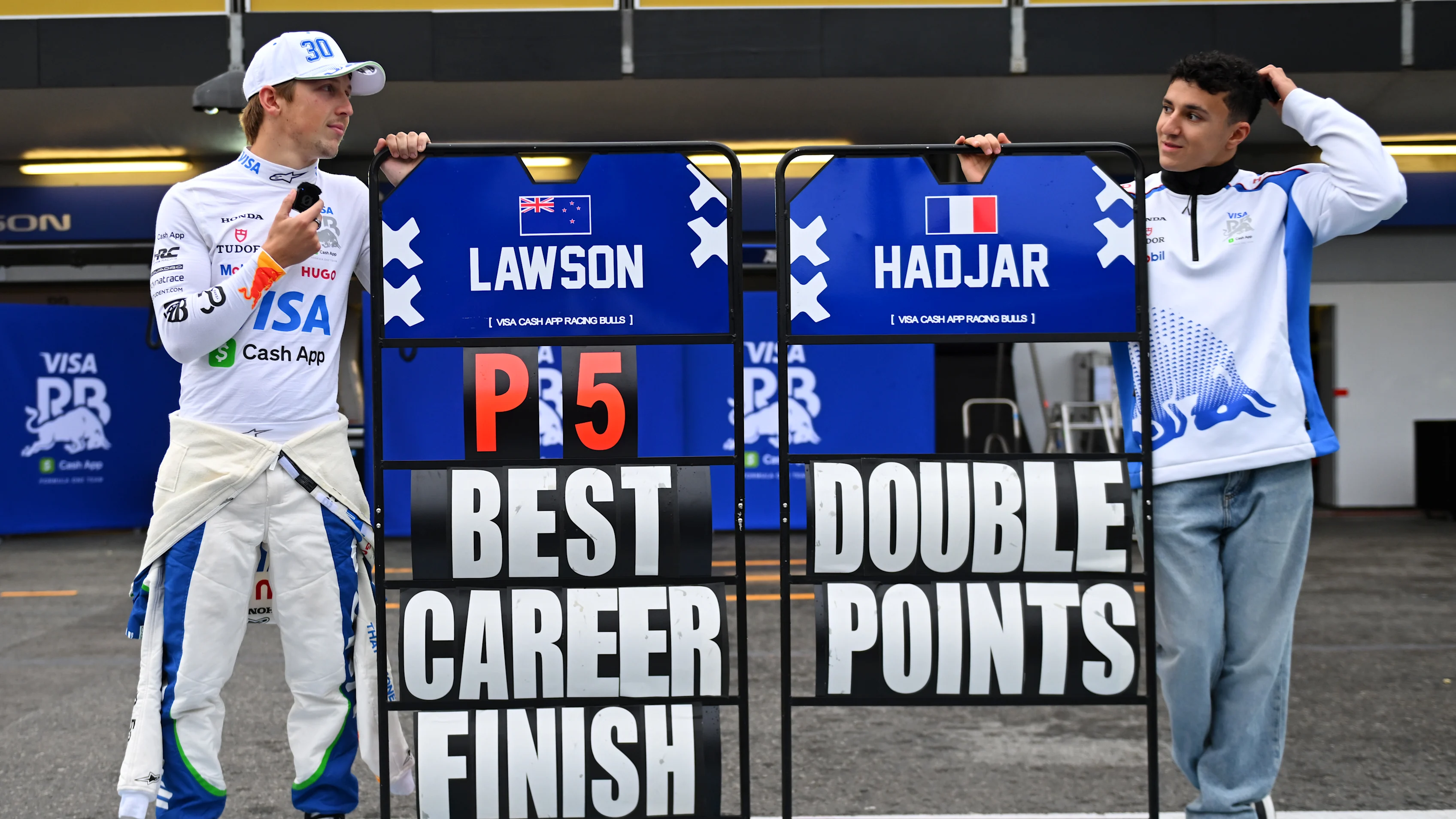 BAKU, AZERBAIJAN - SEPTEMBER 21: Fifth placed Liam Lawson of New Zealand and Visa Cash App Racing Bulls and Tenth placed Isack Hadjar of France and Visa Cash App Racing Bulls celebrate during the F1 Grand Prix of Azerbaijan at Baku City Circuit on September 21, 2025 in Baku, Azerbaijan. (Photo by Rudy Carezzevoli/Getty Images)