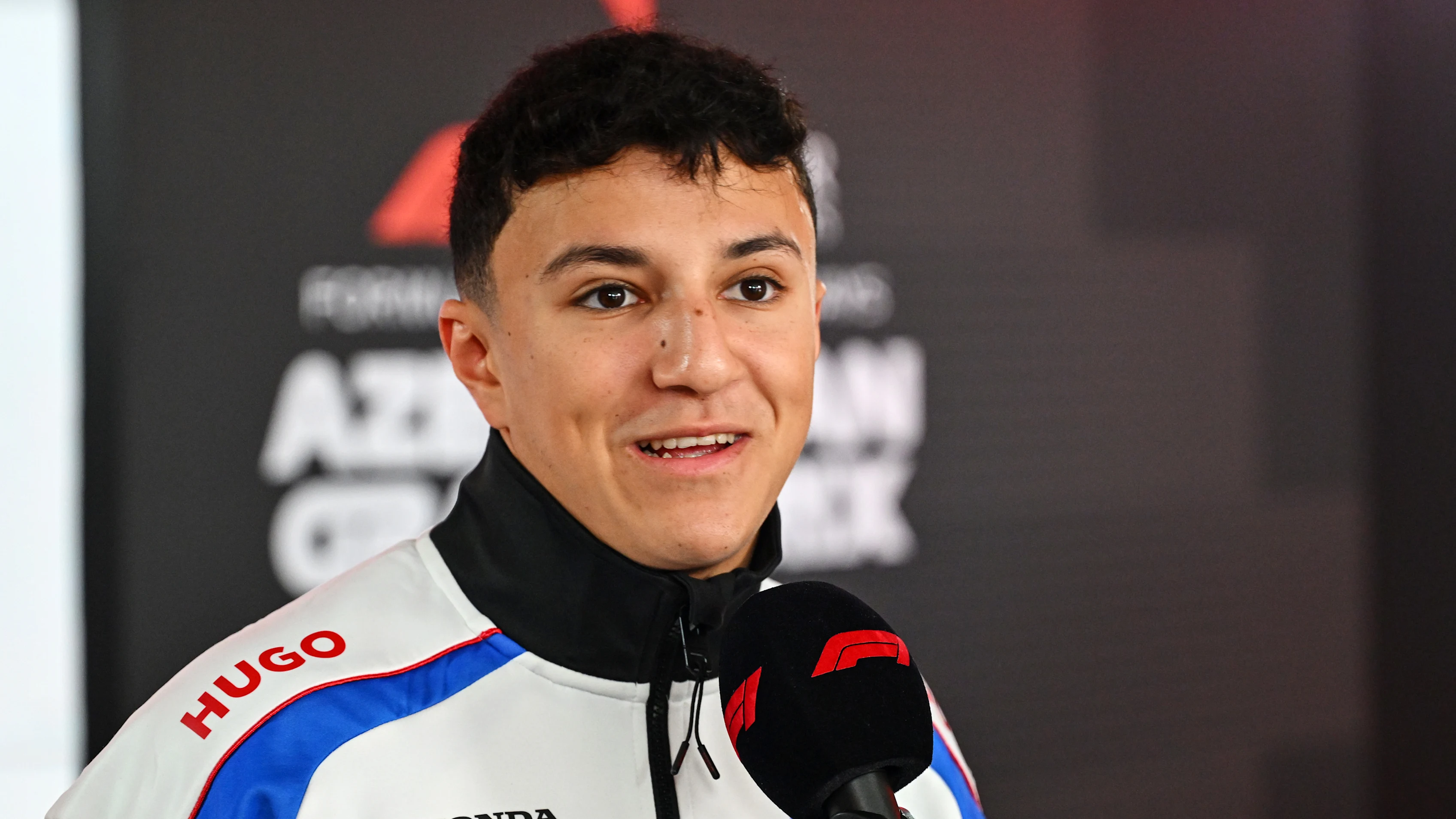 BAKU, AZERBAIJAN - SEPTEMBER 18: Isack Hadjar of France and Visa Cash App Racing Bulls talks to the