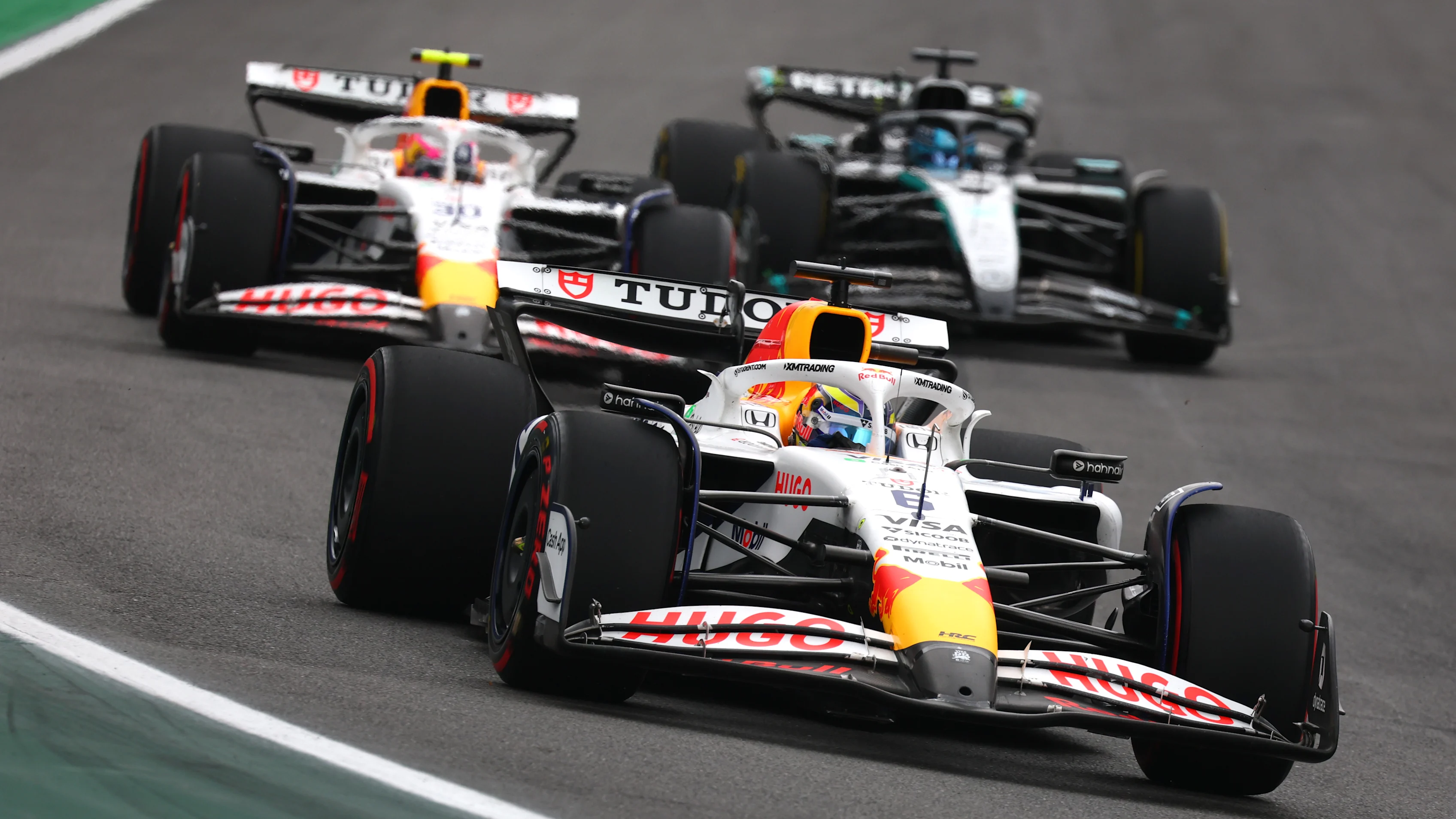 SAO PAULO, BRAZIL - NOVEMBER 09: Isack Hadjar of France driving the (6) Visa Cash App Racing Bulls VCARB 02 leads Liam Lawson of New Zealand driving the (30) Visa Cash App Racing Bulls VCARB 02 and George Russell of Great Britain driving the (63) Mercedes AMG Petronas F1 Team W16 on track during the F1 Grand Prix of Brazil at Autodromo Jose Carlos Pace on November 09, 2025 in Sao Paulo, Brazil. (Photo by Mark Thompson/Getty Images)