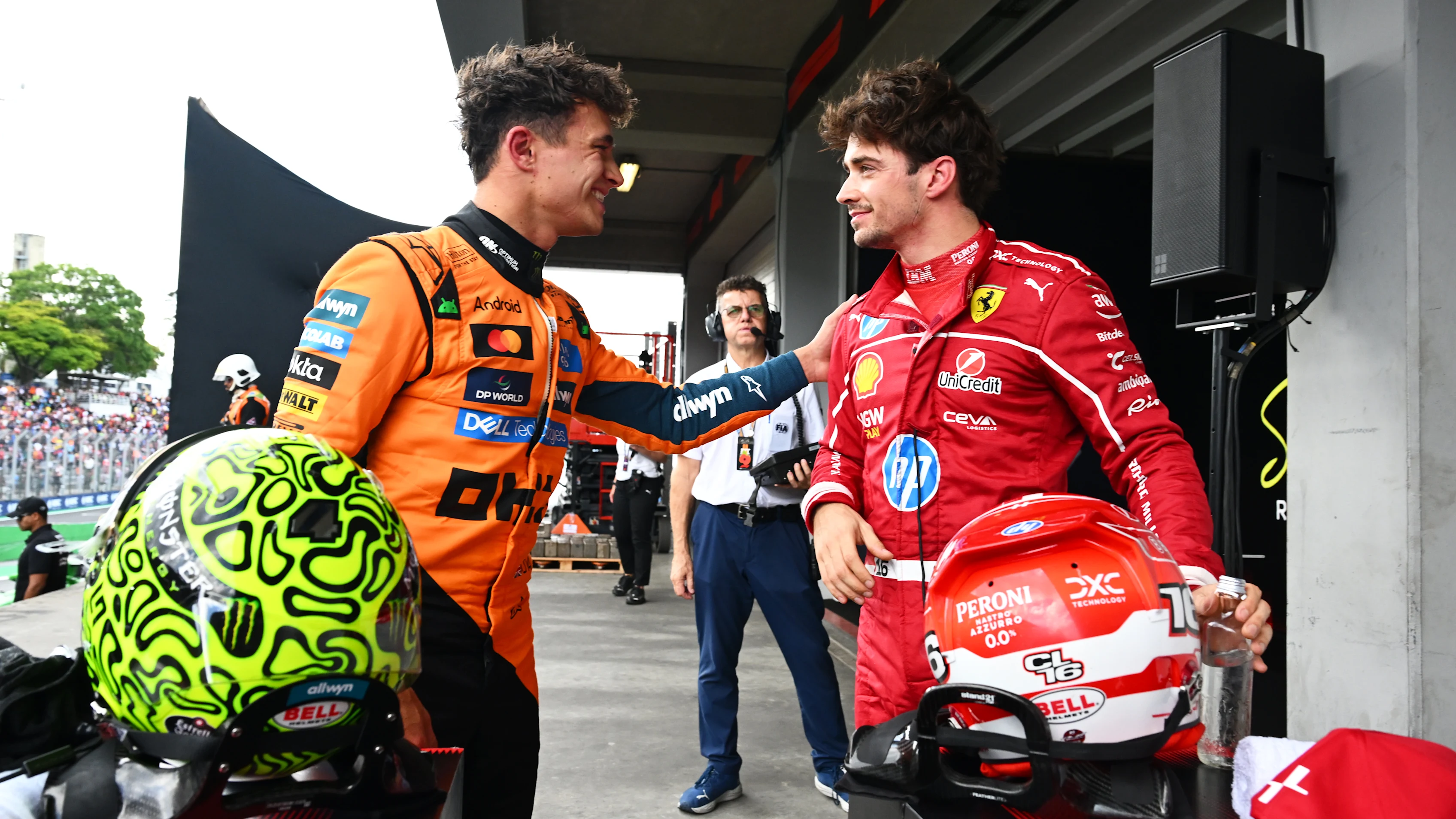 SAO PAULO, BRAZIL - NOVEMBER 08: Pole position qualifier Lando Norris of Great Britain and McLaren and Third placed qualifier Charles Leclerc of Monaco and Scuderia Ferrari talk in parc ferme during qualifying ahead of the F1 Grand Prix of Brazil at Autodromo Jose Carlos Pace on November 08, 2025 in Sao Paulo, Brazil. (Photo by Mark Sutton - Formula 1/Formula 1 via Getty Images)