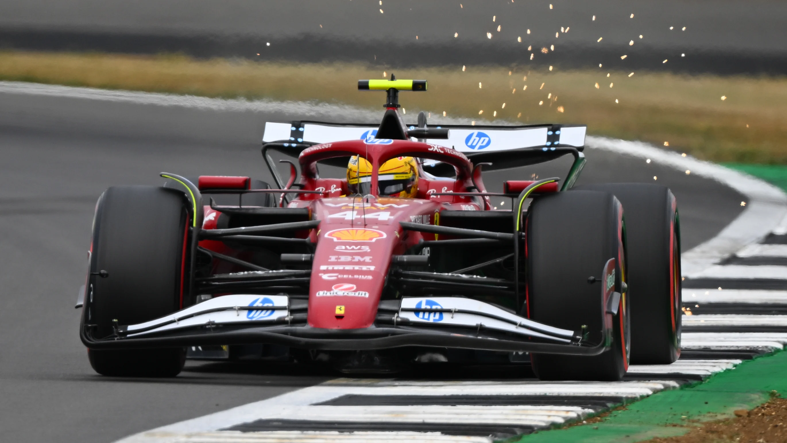 NORTHAMPTON, ENGLAND - JULY 05: Sparks fly behind Lewis Hamilton of Great Britain driving the (44)