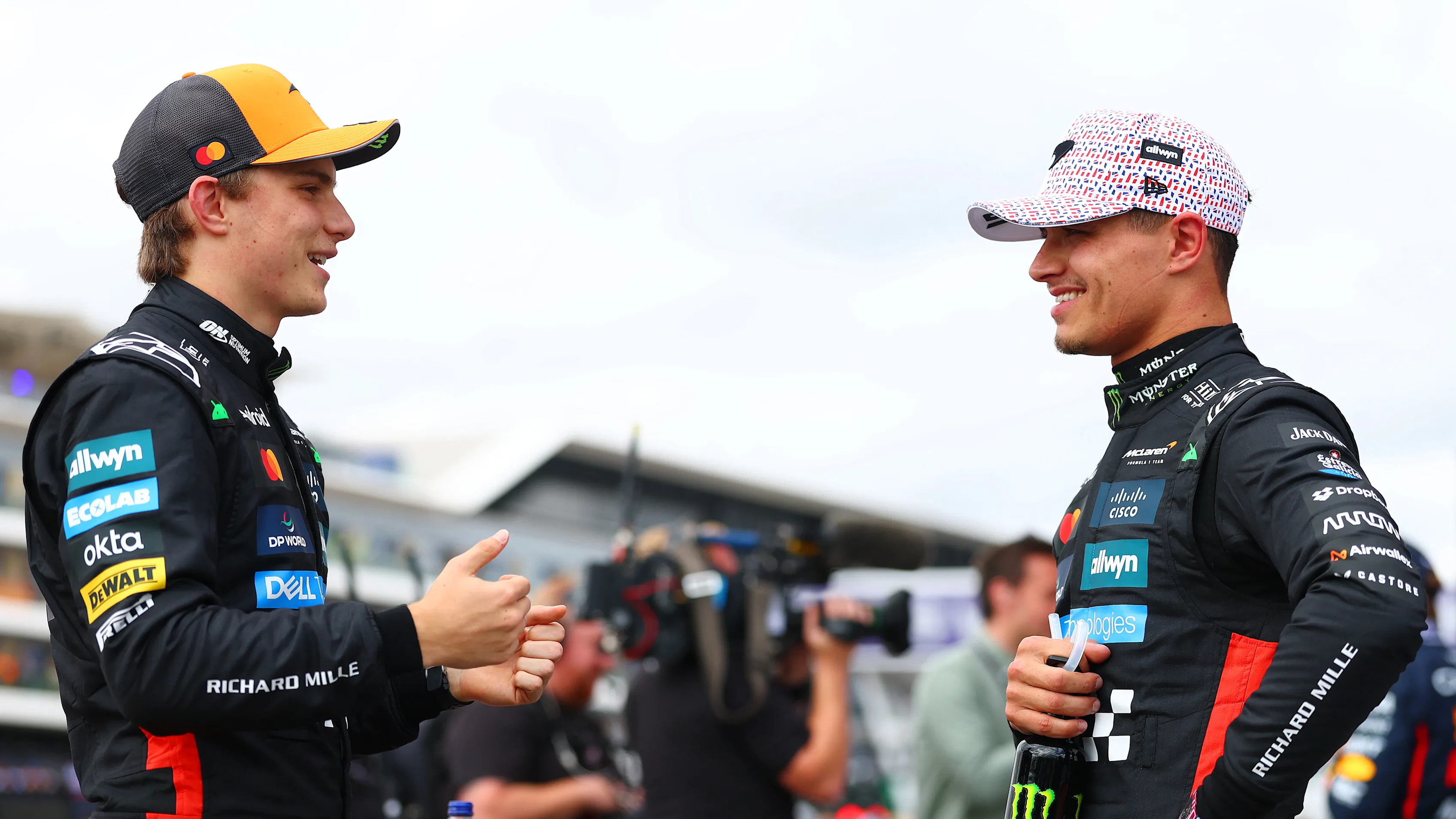 NORTHAMPTON, ENGLAND - JULY 05: Second placed qualifier Oscar Piastri of Australia and McLaren and Third placed qualifier Lando Norris of Great Britain and McLaren talk in parc ferme during qualifying ahead of the F1 Grand Prix of Great Britain at Silverstone Circuit on July 05, 2025 in Northampton, England. (Photo by Bryn Lennon - Formula 1/Formula 1 via Getty Images)
