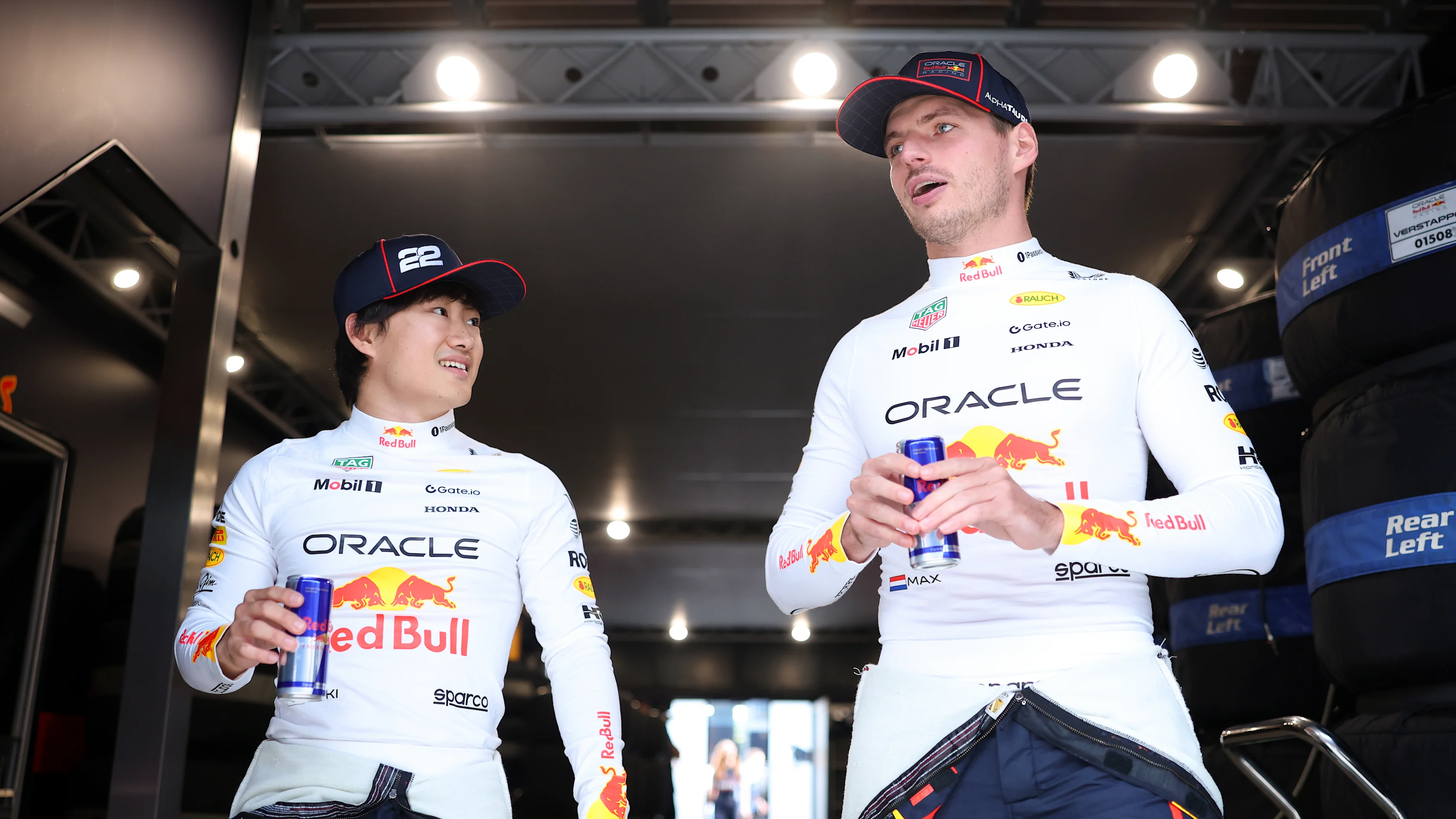 BUDAPEST, HUNGARY - AUGUST 01: Yuki Tsunoda of Japan and Oracle Red Bull Racing talks with Max