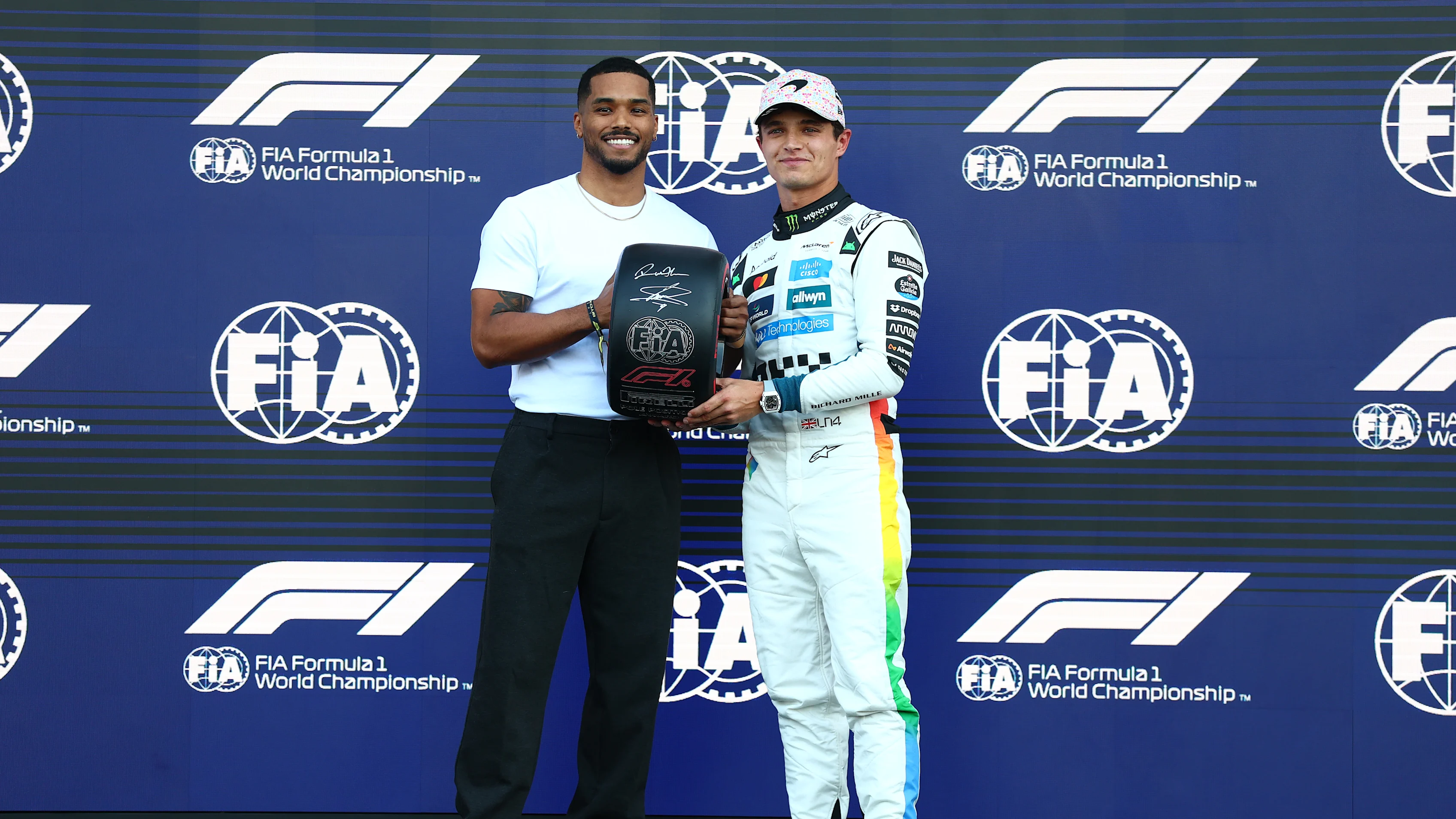 MEXICO CITY, MEXICO - OCTOBER 25: Rome Flynn presents Pole position qualifier Lando Norris of Great