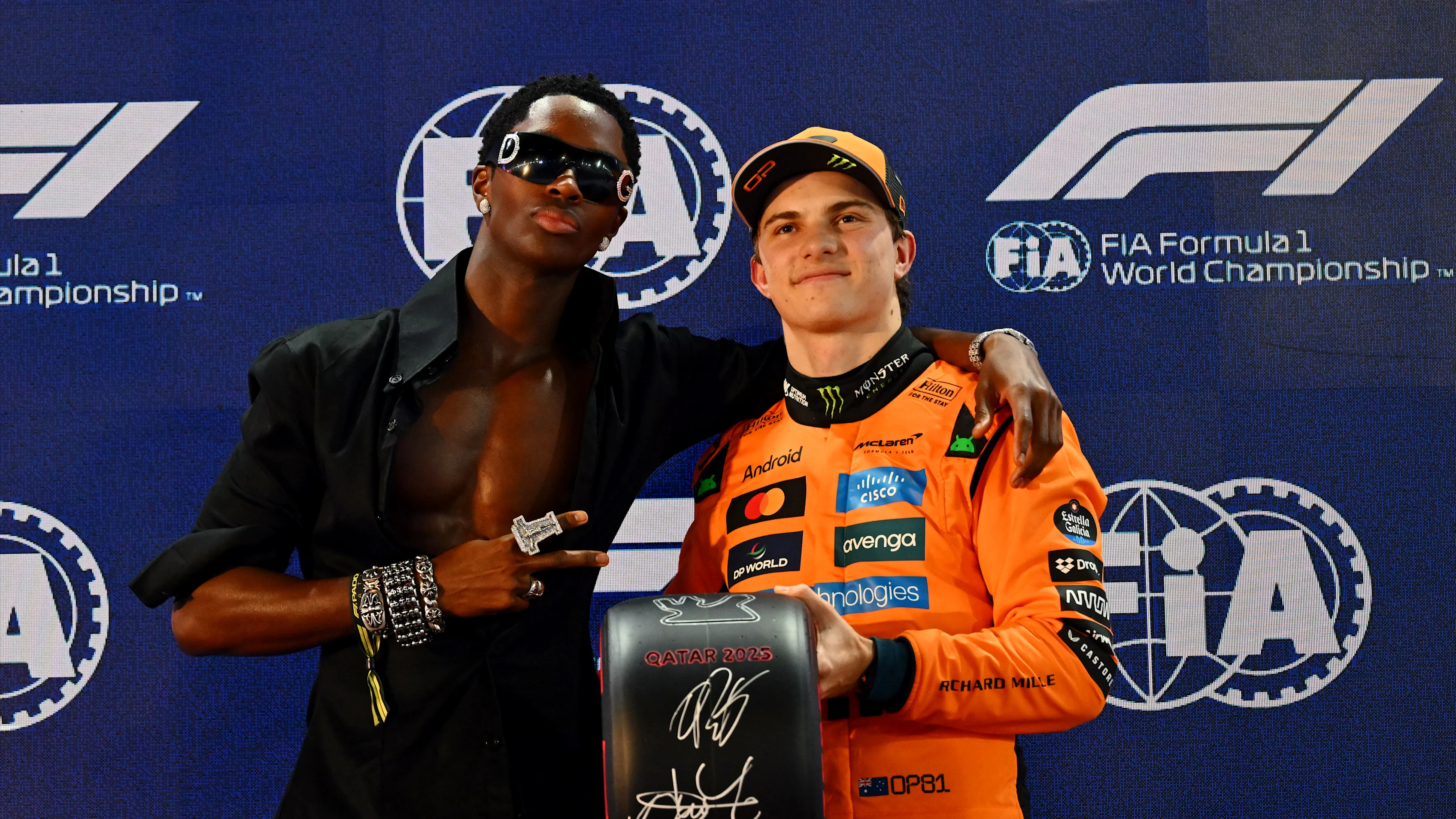 LUSAIL CITY, QATAR - NOVEMBER 29: Alton Mason presents Pole position qualifier Oscar Piastri of