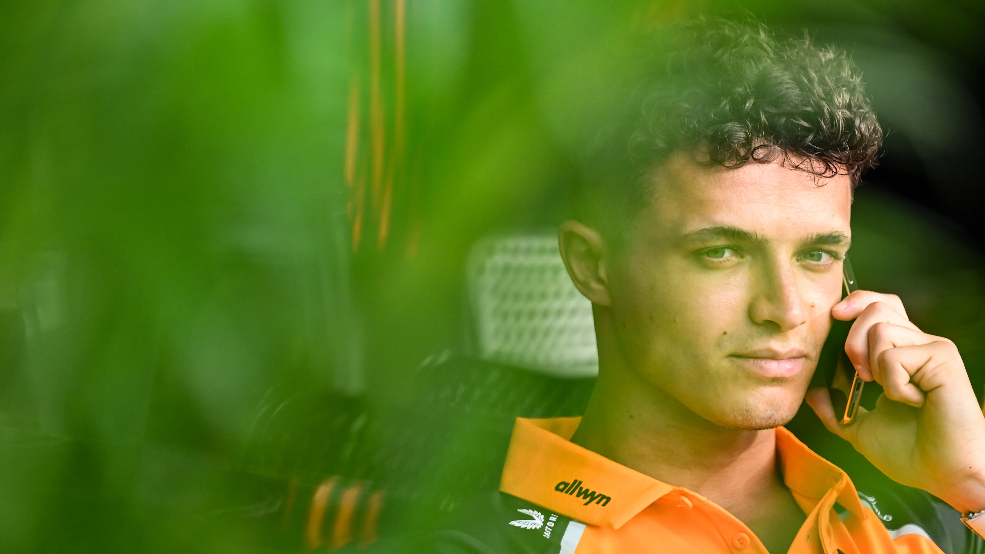 JEDDAH, SAUDI ARABIA - APRIL 17: Lando Norris of Great Britain and McLaren talks on the phone