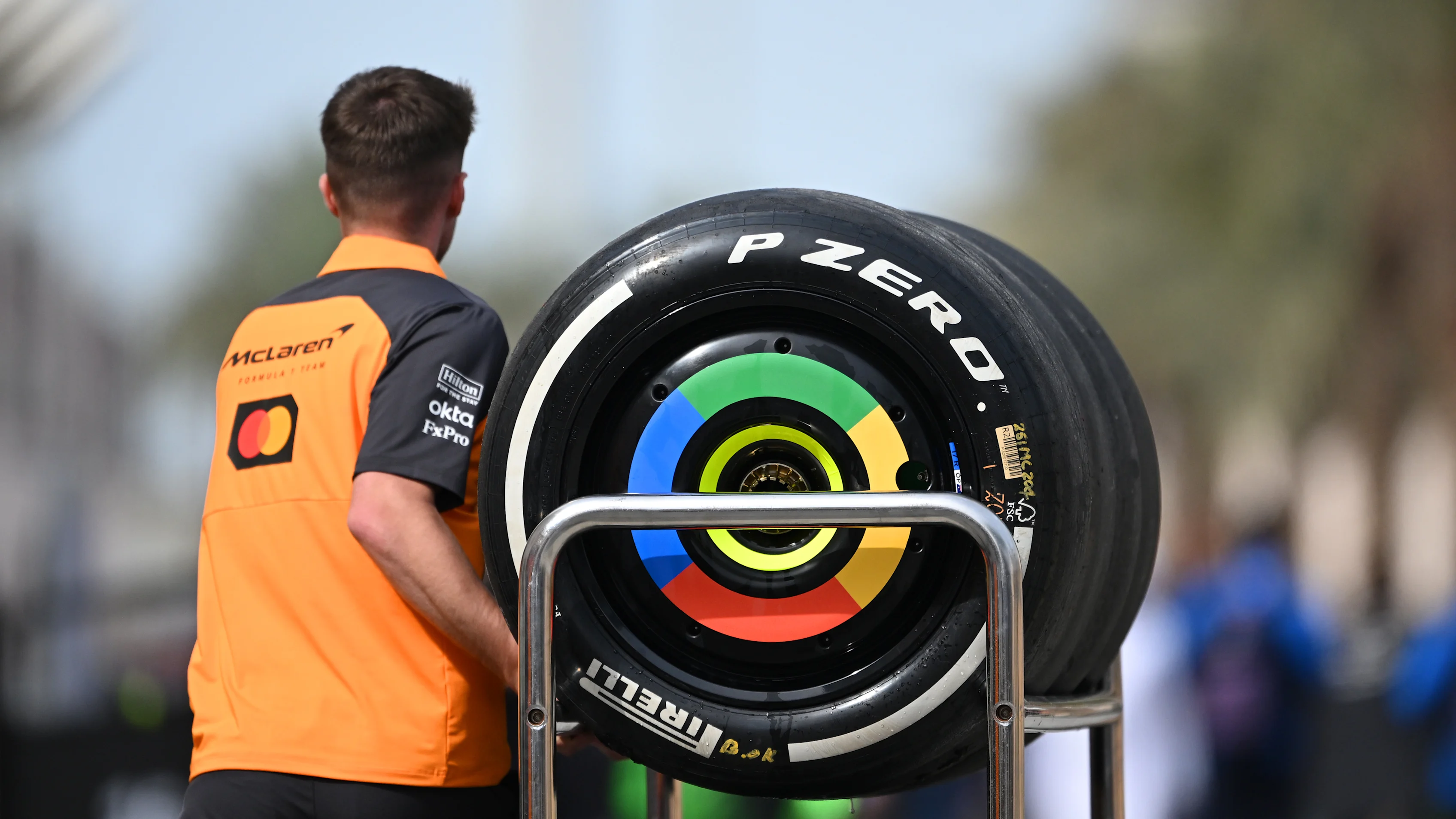 BAHRAIN, BAHRAIN - FEBRUARY 28: A team member of McLaren pushes a trolley of tyres through the