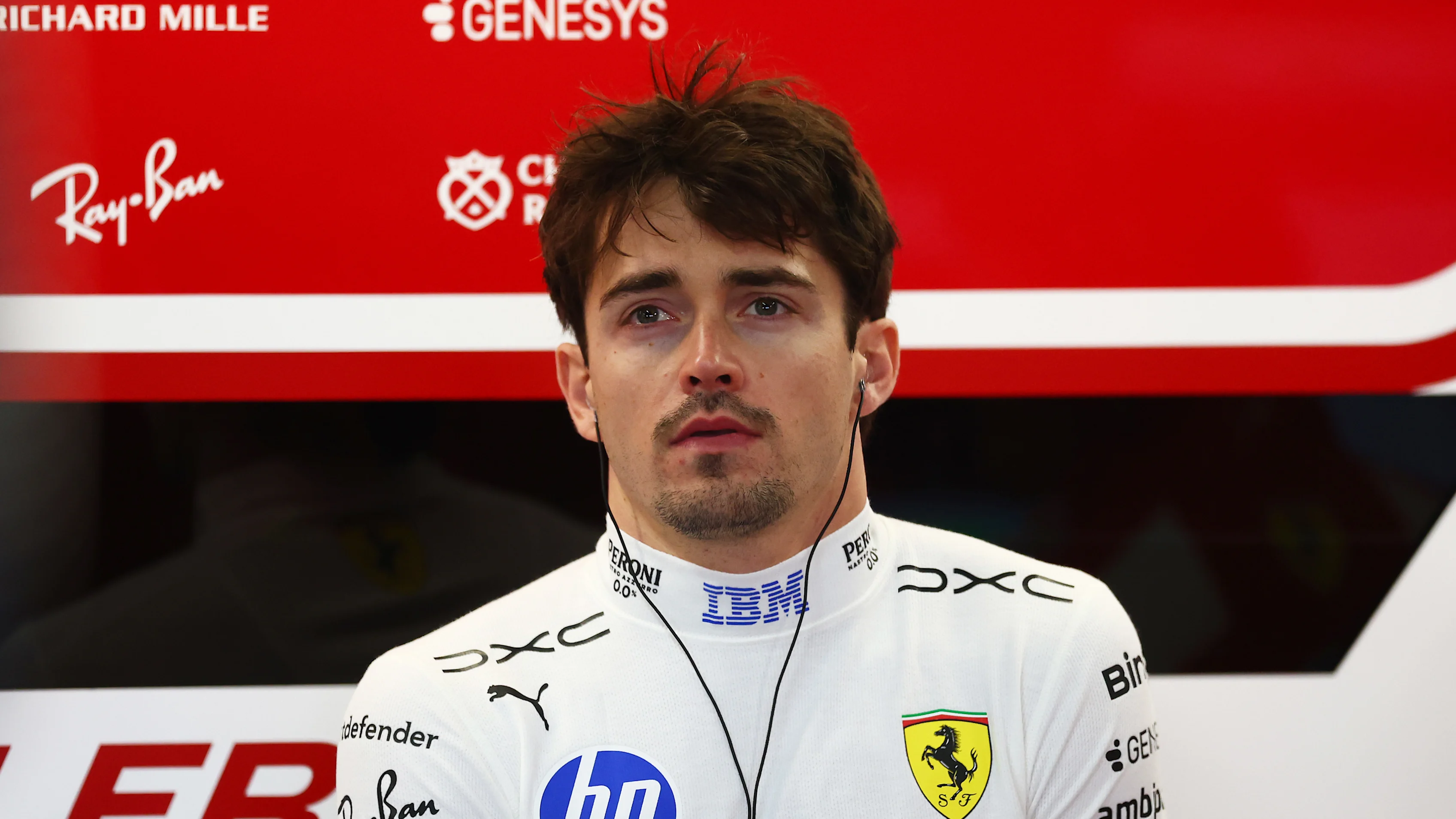 SUZUKA, JAPAN - MARCH 27: Charles Leclerc of Monaco and Scuderia Ferrari looks on in the garage