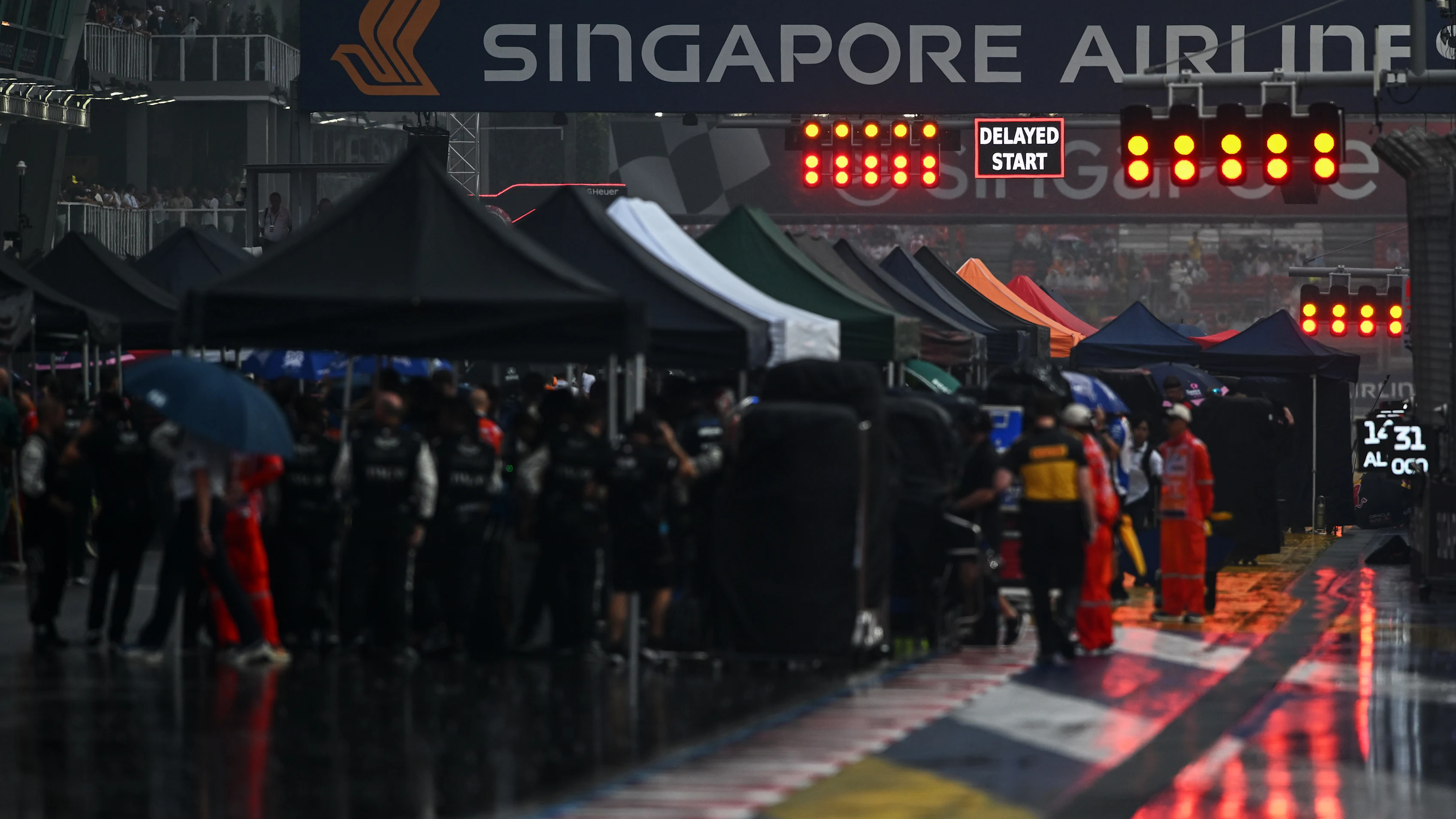 SINGAPORE, SINGAPORE - OCTOBER 10: The FIA Safety Car and drivers line up on the grid prior to the