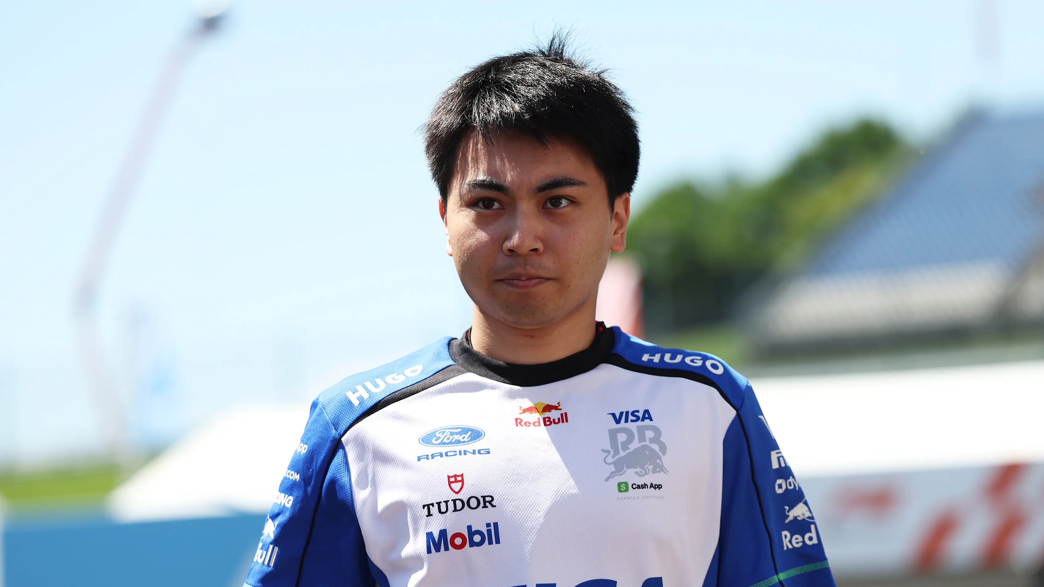 SPIELBERG, AUSTRIA - JUNE 25: Ayumu Iwasa of Japan and Visa Cash App Racing Bulls walks in the