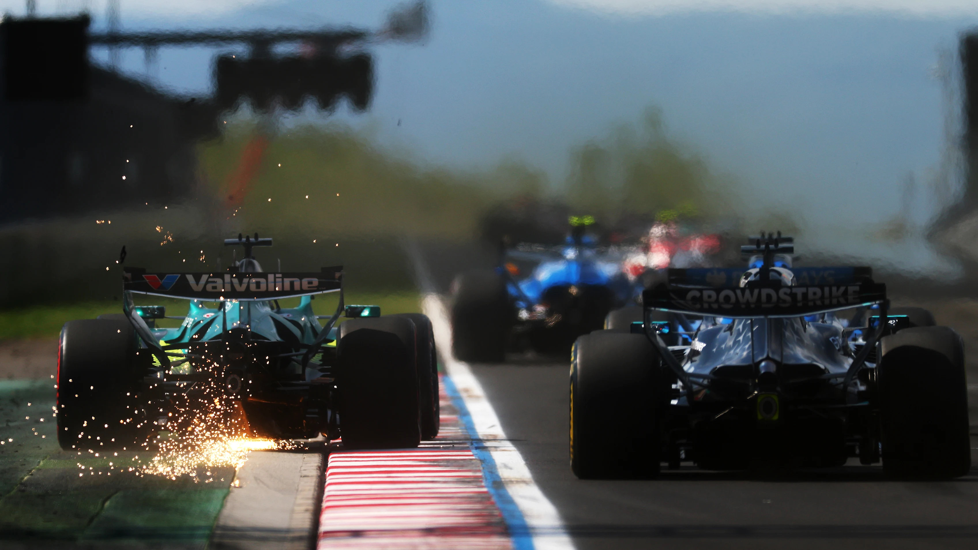 BUDAPEST, HUNGARY - JULY 26: Sparks fly behind Lance Stroll of Canada driving the (18) Aston Martin