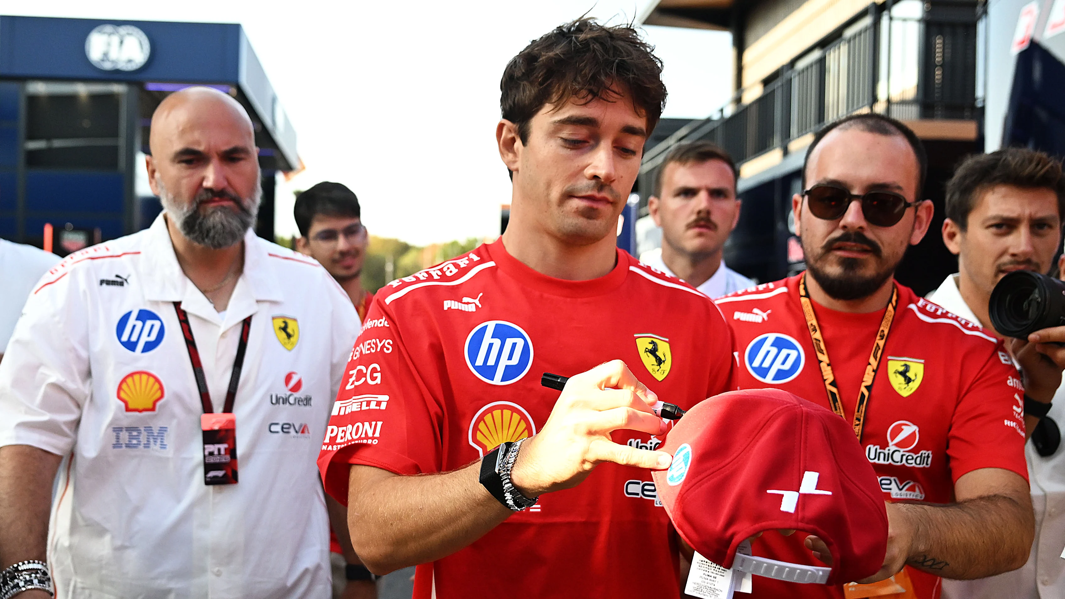MONZA, ITALY - SEPTEMBER 06: Charles Leclerc of Monaco and Scuderia Ferrari signs an autograph