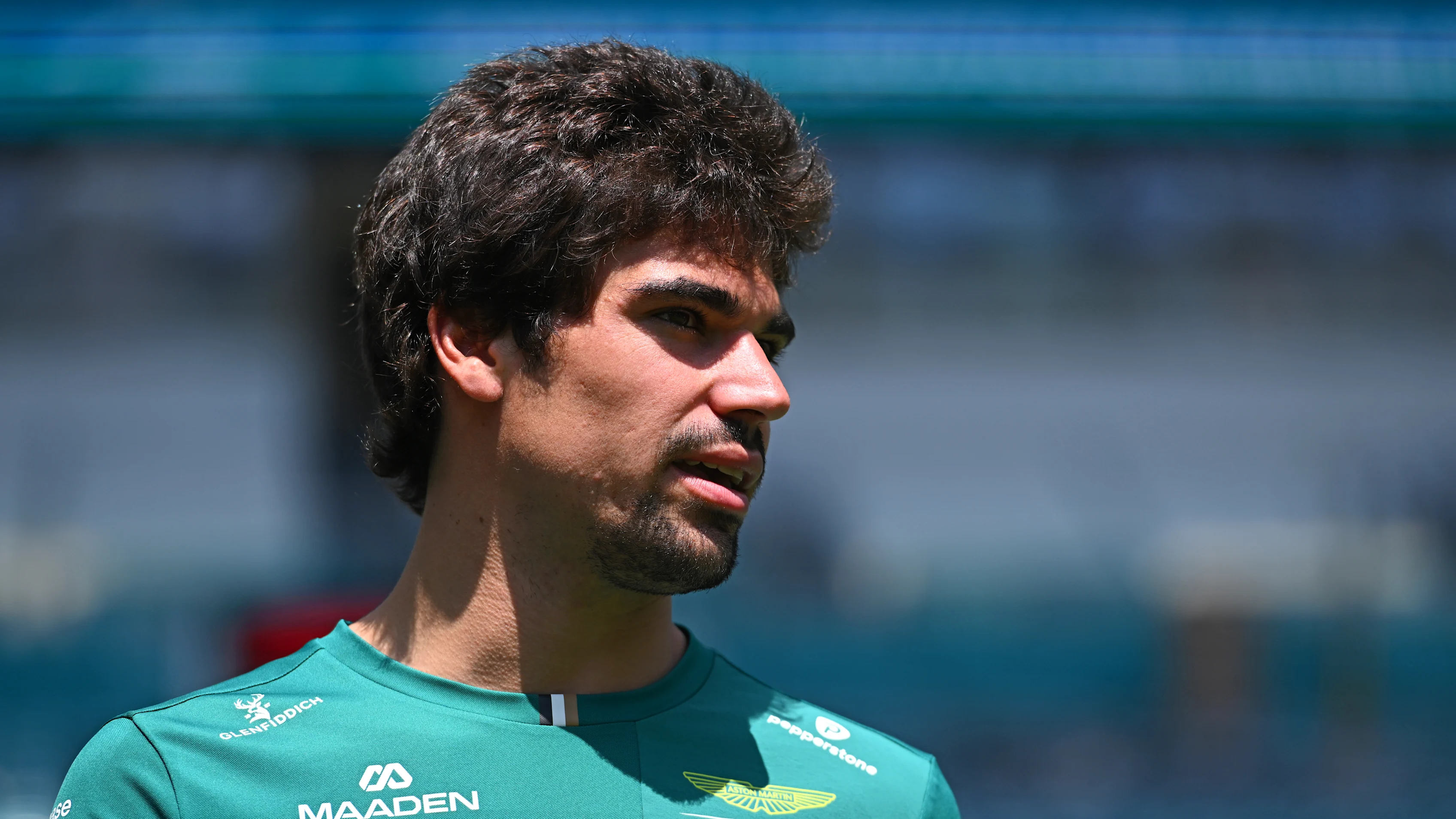 MIAMI, FLORIDA - APRIL 30: Lance Stroll of Canada and Aston Martin F1 Team walks in the Paddock