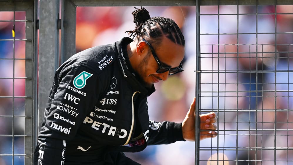 NORTHAMPTON, ENGLAND - JULY 07: Lewis Hamilton of Great Britain and Mercedes climbs through a pit