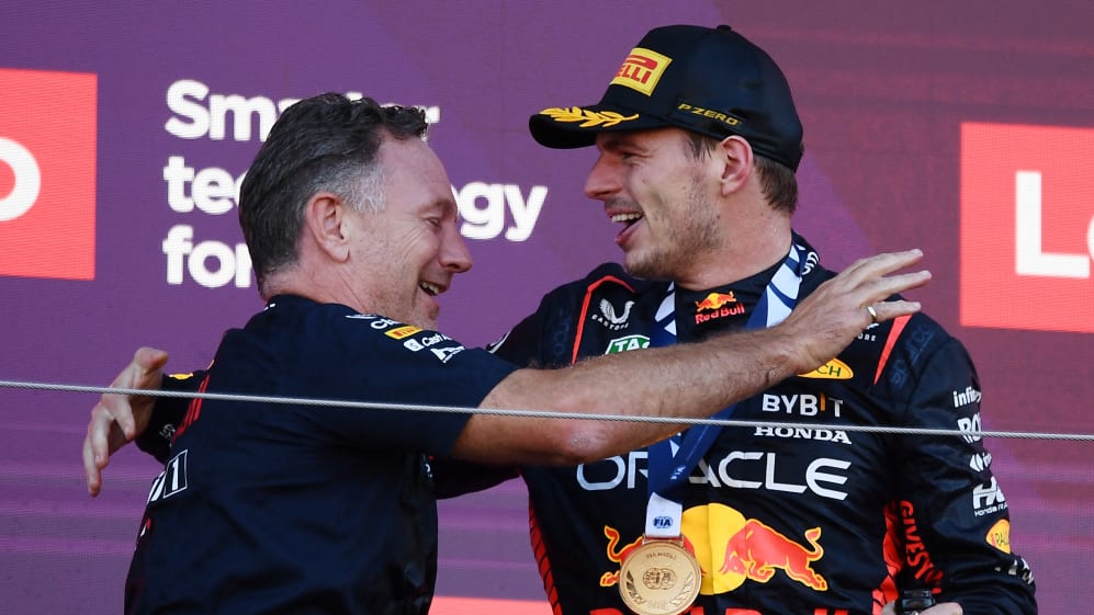Red Bull Racing's Dutch driver Max Verstappen (R) celebrates his victory with Red Bull Racing team