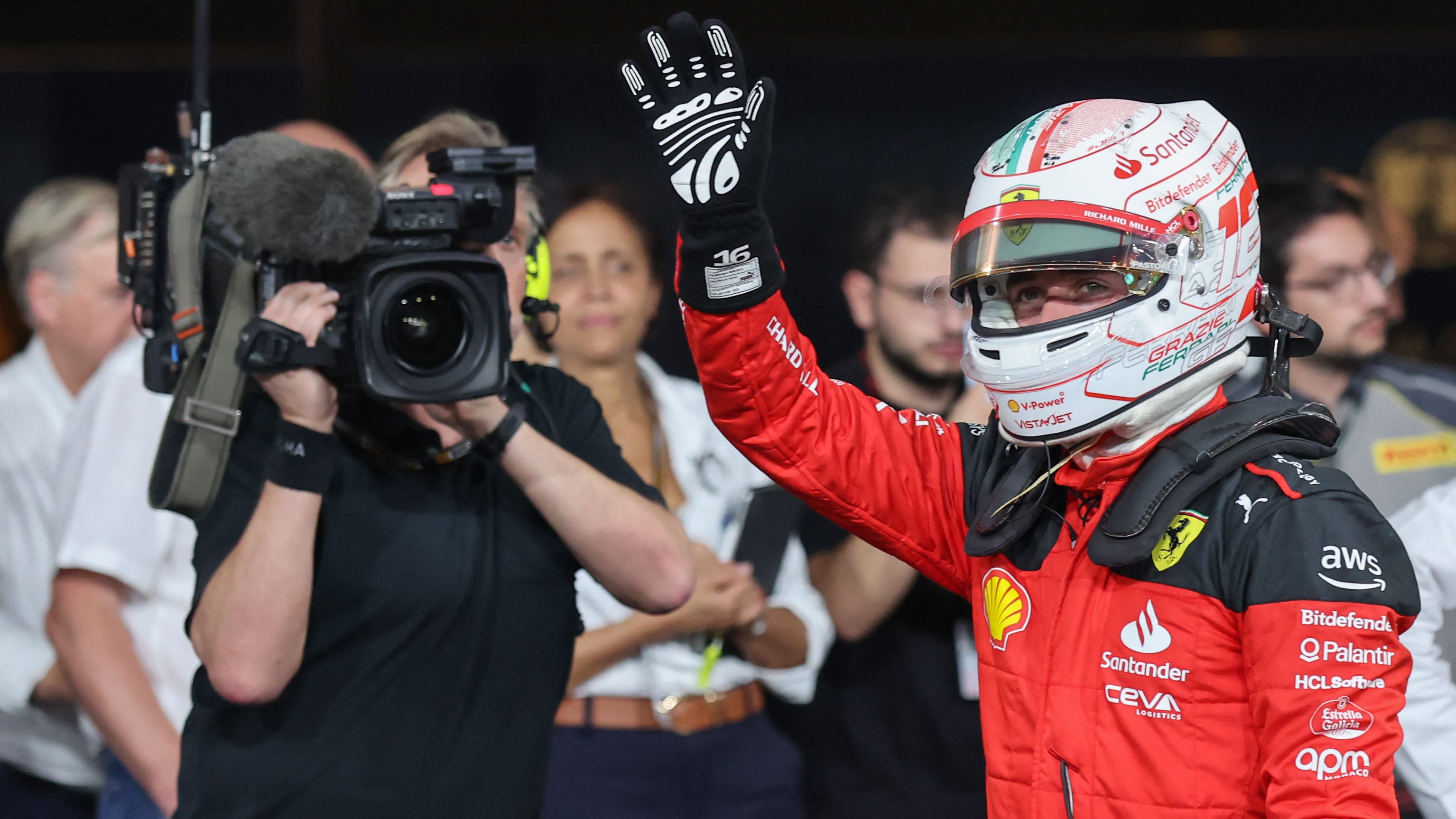 Ferrari's Monegasque driver Charles Leclerc greets the fans after finishing with the second best