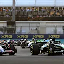 ABU DHABI, UNITED ARAB EMIRATES - DECEMBER 08: Lance Stroll of Canada driving the (18) Aston Martin AMR24 Mercedes leads Liam Lawson of New Zealand driving the (30) Visa Cash App RB VCARB 01 on track during the F1 Grand Prix of Abu Dhabi at Yas Marina Circuit on December 08, 2024 in Abu Dhabi, United Arab Emirates. (Photo by Clive Mason/Getty Images)