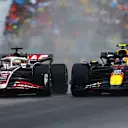 MONTREAL, QUEBEC - JUNE 09: Sergio Perez of Mexico driving the (11) Oracle Red Bull Racing RB20 and Kevin Magnussen of Denmark driving the (20) Haas F1 VF-24 Ferrari battle for position on track during the F1 Grand Prix of Canada at Circuit Gilles Villeneuve on June 09, 2024 in Montreal, Quebec. (Photo by Mark Thompson/Getty Images)