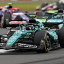 NORTHAMPTON, ENGLAND - JULY 07: Fernando Alonso of Spain driving the (14) Aston Martin AMR24 Mercedes leads Lance Stroll of Canada driving the (18) Aston Martin AMR24 Mercedes during the F1 Grand Prix of Great Britain at Silverstone Circuit on July 07, 2024 in Northampton, England. (Photo by Peter Fox - Formula 1/Formula 1 via Getty Images)
