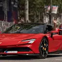 Sainz waves to his home fans as he takes a spin in a Ferrari road car