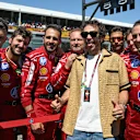 Valentino Rossi poses for a photo with the Ferrari team on the grid