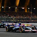 SINGAPORE, SINGAPORE - SEPTEMBER 22: Yuki Tsunoda of Japan driving the (22) Visa Cash App RB VCARB 01 leads Lewis Hamilton of Great Britain driving the (44) Mercedes AMG Petronas F1 Team W15 on track during the F1 Grand Prix of Singapore at Marina Bay Street Circuit on September 22, 2024 in Singapore, Singapore. (Photo by Mark Thompson/Getty Images)