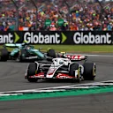NORTHAMPTON, ENGLAND - JULY 07: Nico Hulkenberg of Germany driving the (27) Haas F1 VF-24 Ferrari leads Fernando Alonso of Spain driving the (14) Aston Martin AMR24 Mercedes during the F1 Grand Prix of Great Britain at Silverstone Circuit on July 07, 2024 in Northampton, England. (Photo by Peter Fox - Formula 1/Formula 1 via Getty Images)