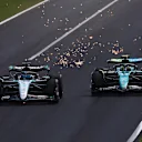 MONZA, ITALY - SEPTEMBER 01: George Russell of Great Britain driving the (63) Mercedes AMG Petronas F1 Team W15 battle for track position with Fernando Alonso of Spain driving the (14) Aston Martin AMR24 Mercedes during the F1 Grand Prix of Italy at Autodromo Nazionale Monza on September 01, 2024 in Monza, Italy. (Photo by Joe Portlock - Formula 1/Formula 1 via Getty Images)