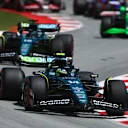 BARCELONA, SPAIN - JUNE 23: Fernando Alonso of Spain driving the (14) Aston Martin AMR24 Mercedes leads Lance Stroll of Canada driving the (18) Aston Martin AMR24 Mercedes during the F1 Grand Prix of Spain at Circuit de Barcelona-Catalunya on June 23, 2024 in Barcelona, Spain. (Photo by Clive Rose - Formula 1/Formula 1 via Getty Images)