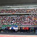 SHANGHAI, CHINA - MARCH 23: Drivers and team personnel gather in tribute to the late Eddie Jordan