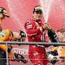 SPA, BELGIUM - JULY 27: Race winner Oscar Piastri of Australia and McLaren Second placed Lando Norris of Great Britain and McLaren Third placed Charles Leclerc of Monaco and Scuderia Ferrari and the McLaren trophy delegate celebrate with Champagne on the podium during the F1 Grand Prix of Belgium at Circuit de Spa-Francorchamps on July 27, 2025 in Spa, Belgium. (Photo by Ryan Pierse/Getty Images)