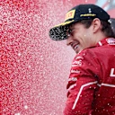 SPA, BELGIUM - JULY 27: Third placed Charles Leclerc of Monaco and Scuderia Ferrari celebrates with Champagne on the podium during the F1 Grand Prix of Belgium at Circuit de Spa-Francorchamps on July 27, 2025 in Spa, Belgium. (Photo by Mark Thompson/Getty Images)