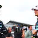 NORTHAMPTON, ENGLAND - JULY 05: Second placed qualifier Oscar Piastri of Australia and McLaren and Third placed qualifier Lando Norris of Great Britain and McLaren talk in parc ferme during qualifying ahead of the F1 Grand Prix of Great Britain at Silverstone Circuit on July 05, 2025 in Northampton, England. (Photo by Bryn Lennon - Formula 1/Formula 1 via Getty Images)