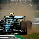 NORTHAMPTON, ENGLAND - JULY 05: Sparks and mud fly behind Fernando Alonso of Spain driving the (14) Aston Martin F1 Team AMR25 Mercedes on track  during qualifying ahead of the F1 Grand Prix of Great Britain at Silverstone Circuit on July 05, 2025 in Northampton, England. (Photo by Clive Mason/Getty Images)