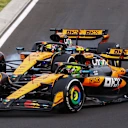 BUDAPEST, HUNGARY - AUGUST 03: Lando Norris of Great Britain driving the (4) McLaren MCL39 Mercedes and Oscar Piastri of Australia driving the (81) McLaren MCL39 Mercedes battle for track position during the F1 Grand Prix of Hungary at Hungaroring on August 03, 2025 in Budapest, Hungary. (Photo by Joe Portlock/Getty Images)