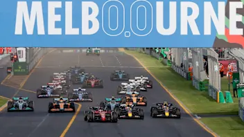 Ferrari's Monegasque driver Charles Leclerc (C) leads a pack at the start of the 2022 Formula One