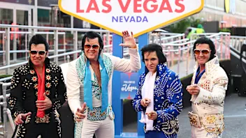 LAS VEGAS, NEVADA - NOVEMBER 19: Elvis Presley impersonators pose for a photo in front of the