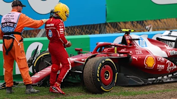 ZANDVOORT, NETHERLANDS - AUGUST 31: A marshal assists Lewis Hamilton of Great Britain and Scuderia