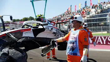 MADRID, SPAIN - SEPTEMBER 12: Marshals extract the damaged Haas VF-26 of Oliver Bearman of Great